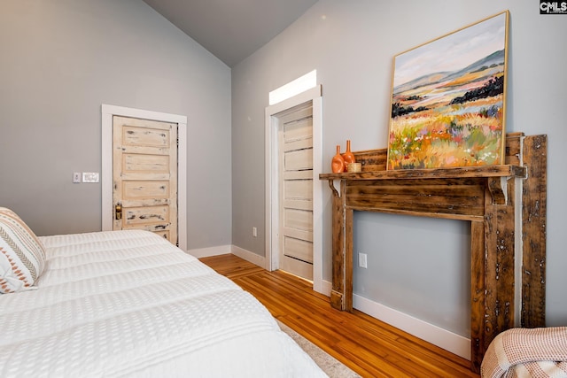 2808 River Dr, Columbia, SC 29201 - bedroom with lofted ceiling, wood finished floors, and baseboards