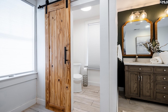 2808 River Dr, Columbia, SC 29201 - bathroom featuring vanity, toilet, wood finished floors, and baseboards