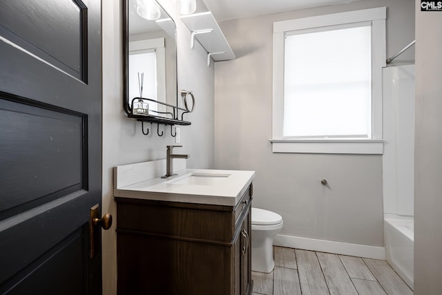 2808 River Dr, Columbia, SC 29201 - full bathroom featuring vanity, baseboards, wood finish floors, toilet, and bathing tub / shower combination