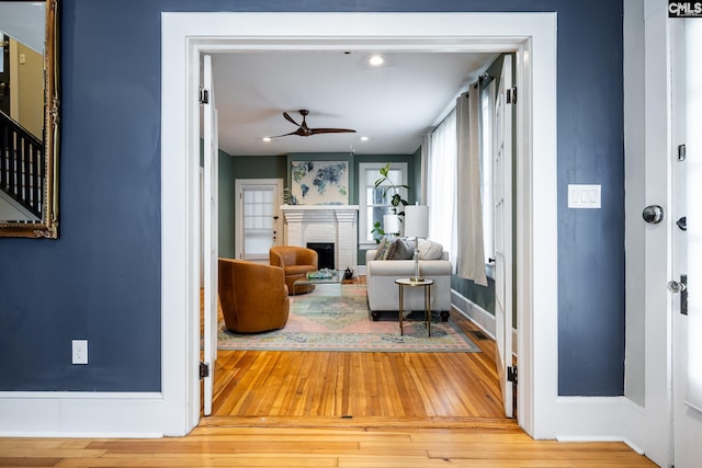 2808 River Dr, Columbia, SC 29201 - living room featuring ceiling fan, hardwood / wood-style floors, a fireplace, and baseboards