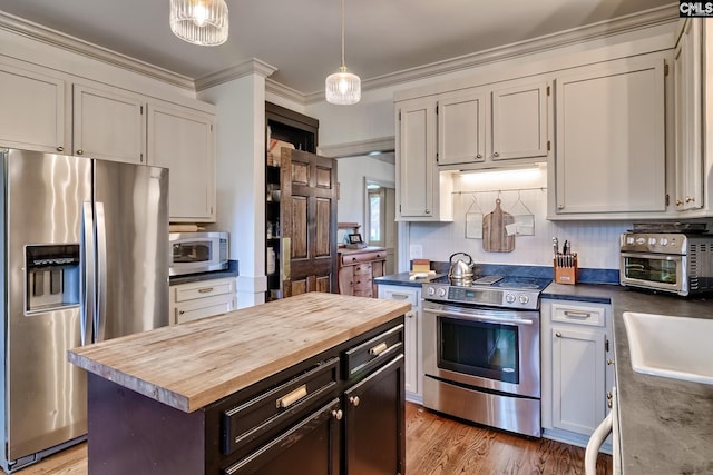 205 Weeping Cherry Ln, Columbia, SC 29212 - kitchen featuring stainless steel appliances, butcher block countertops, crown molding, pendant lighting, and light wood-style flooring