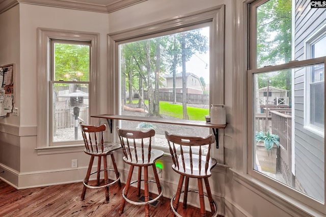 205 Weeping Cherry Ln, Columbia, SC 29212 - dining area featuring wood finished floors, baseboards, crown molding, and a dry bar
