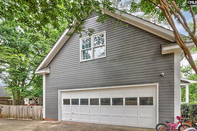 205 Weeping Cherry Ln, Columbia, SC 29212 - view of side of home featuring driveway, a garage, and a security system