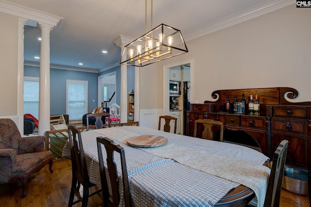108 Shallow Brook Dr, Columbia, SC 29223 - dining space with crown molding, wood finished floors, decorative columns, a wainscoted wall, and a chandelier