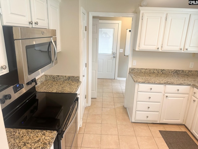 112 Valhalla Dr, Columbia, SC 29229 - kitchen featuring stainless steel appliances, white cabinetry, light tile patterned floors, light stone countertops, and baseboards