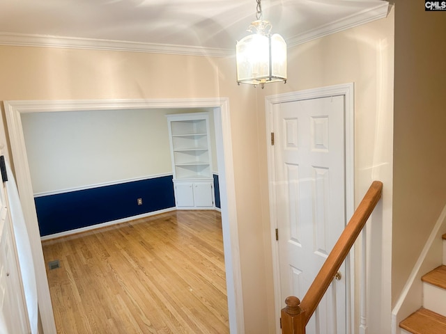 112 Valhalla Dr, Columbia, SC 29229 - corridor with a chandelier, wood finished floors, ornamental molding, built in shelves, and baseboards
