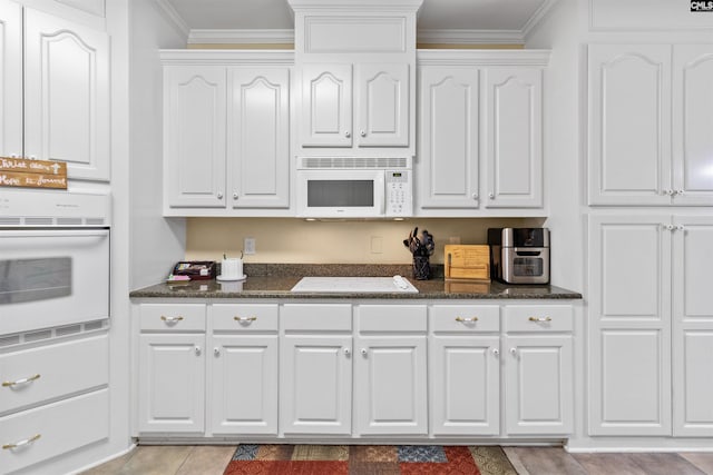 6 Hunting Glen Ct, Irmo, SC 29063 - kitchen with white appliances, white cabinetry, crown molding, dark stone counters, and light tile patterned floors