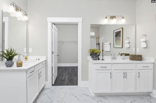 2451 Thode Ln, Lexington, SC 29072 - bathroom featuring marble look tiles, two vanities, and a spacious closet
