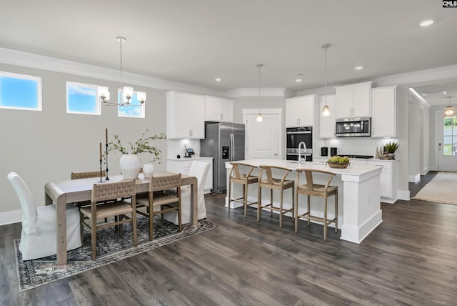 2451 Thode Ln, Lexington, SC 29072 - dining space with a chandelier, dark wood-style floors, recessed lighting, baseboards, and crown molding