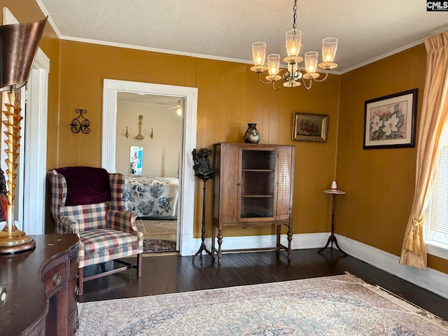 714 E Dunlap St, Lancaster, SC 29720 - living area with a chandelier, crown molding, wood finished floors, a textured ceiling, and baseboards