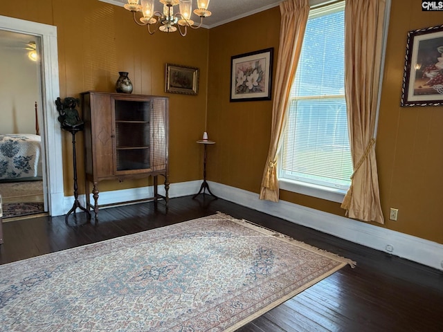 714 E Dunlap St, Lancaster, SC 29720 - detailed view of a chandelier, wood finished floors, crown molding, and baseboards