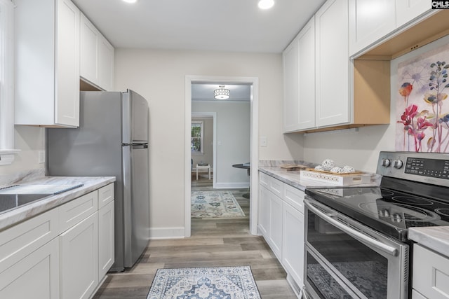 2611 Mills Dr, Columbia, SC 29204 - kitchen featuring stainless steel appliances, white cabinetry, recessed lighting, light wood-type flooring, and baseboards