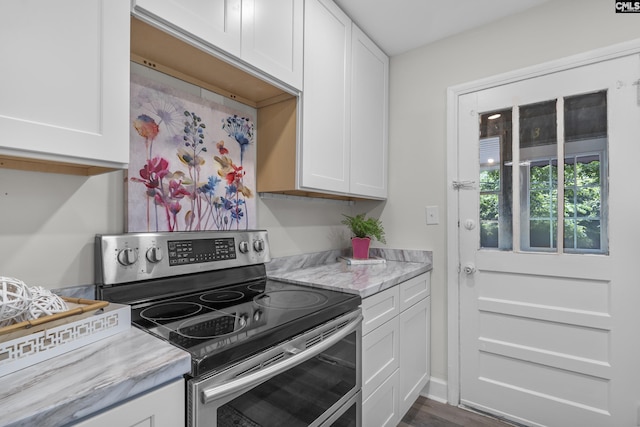 2611 Mills Dr, Columbia, SC 29204 - kitchen featuring stainless steel electric range oven, white cabinetry, and light stone countertops