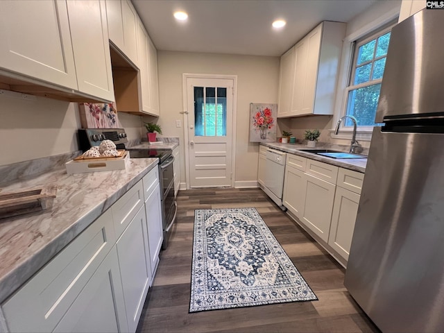 2611 Mills Dr, Columbia, SC 29204 - kitchen with appliances with stainless steel finishes, a sink, dark wood-type flooring, white cabinetry, and recessed lighting