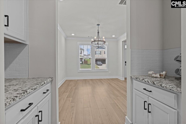 521 Fenwick Dr, Woodruff, SC 29388 - kitchen with ornamental molding, light wood-style floors, a chandelier, decorative backsplash, and baseboards