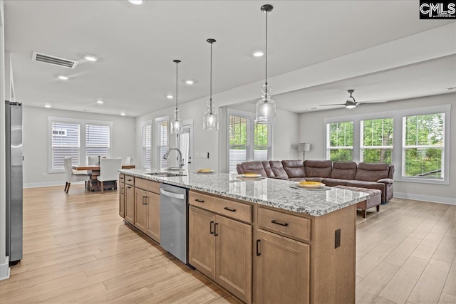 521 Fenwick Dr, Woodruff, SC 29388 - kitchen with stainless steel appliances, a sink, open floor plan, light wood-type flooring, and baseboards