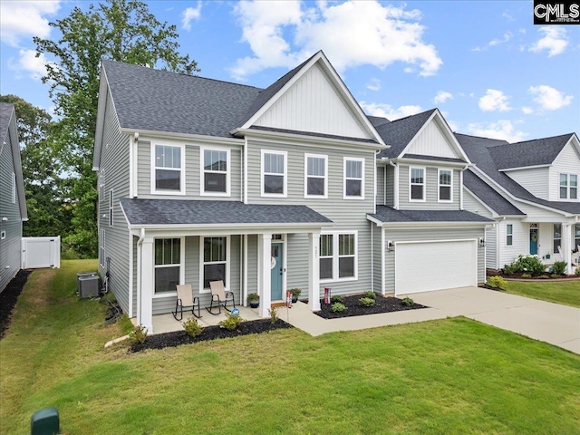521 Fenwick Dr, Woodruff, SC 29388 - view of front of property with covered porch, concrete driveway, board and batten siding, a front yard, and cooling unit