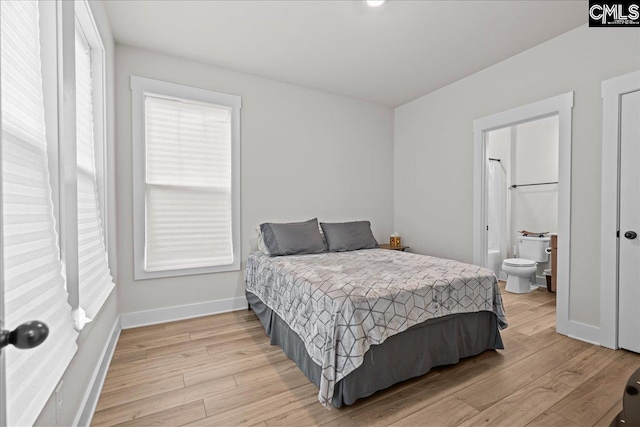 521 Fenwick Dr, Woodruff, SC 29388 - bedroom featuring light wood finished floors, baseboards, and connected bathroom