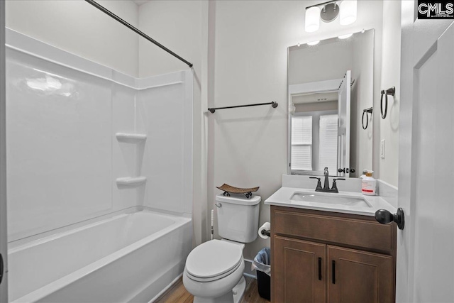 521 Fenwick Dr, Woodruff, SC 29388 - bathroom featuring washtub / shower combination, toilet, vanity, and wood finished floors