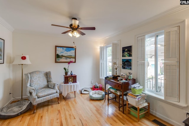4661 Sylvan Dr, Columbia, SC 29206 - living area featuring wood finished floors, a ceiling fan, crown molding, and baseboards