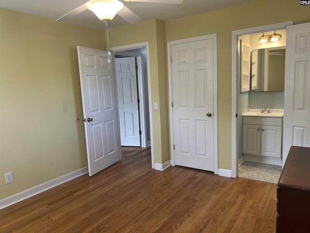 1432 Karlaney Ave, Cayce, SC 29033 - unfurnished bedroom with baseboards, dark wood-style floors, connected bathroom, and a sink