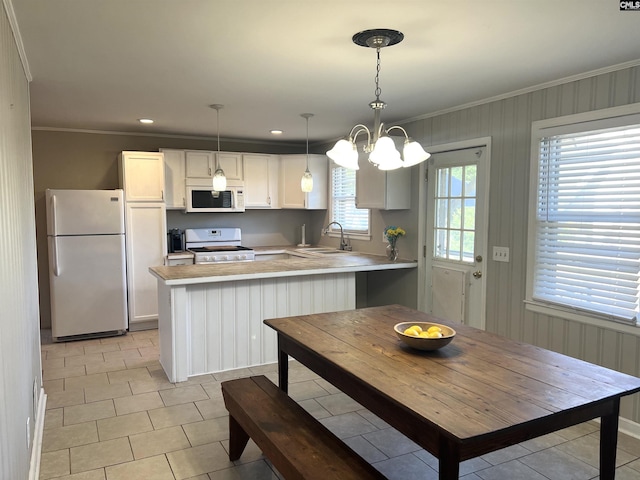 1432 Karlaney Ave, Cayce, SC 29033 - kitchen with white appliances, a sink, crown molding, a peninsula, and light countertops