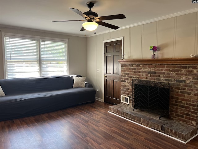 1432 Karlaney Ave, Cayce, SC 29033 - living area with ornamental molding, a decorative wall, a ceiling fan, a fireplace, and dark wood-type flooring