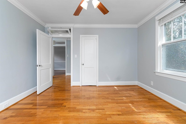 3407 River Dr Unit D, Columbia, SC 29201 - unfurnished bedroom featuring crown molding, baseboards, light wood-style flooring, a ceiling fan, and a closet