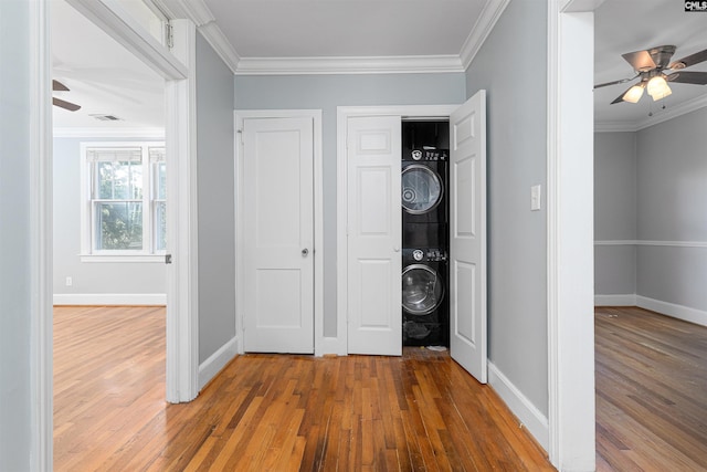 3407 River Dr Unit D, Columbia, SC 29201 - laundry area with stacked washer and clothes dryer, ceiling fan, hardwood / wood-style flooring, baseboards, and ornamental molding
