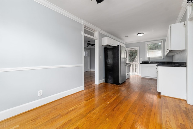 3407 River Dr Unit D, Columbia, SC 29201 - kitchen with freestanding refrigerator, a ceiling fan, white cabinets, crown molding, and a sink