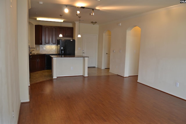 1085 Shop Rd Unit 226, Columbia, SC 29201 - kitchen featuring black refrigerator with ice dispenser, arched walkways, dark wood-style flooring, backsplash, and crown molding