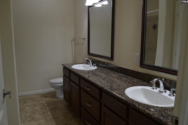 1085 Shop Rd Unit 226, Columbia, SC 29201 - bathroom featuring toilet, double vanity, baseboards, and tile patterned flooring
