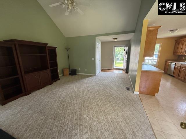 12 Beech Branch Ct, Irmo, SC 29063 - unfurnished living room featuring ceiling fan, light colored carpet, vaulted ceiling, baseboards, and light tile patterned floors