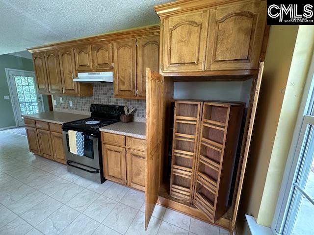 12 Beech Branch Ct, Irmo, SC 29063 - kitchen featuring electric range oven, under cabinet range hood, light countertops, backsplash, and brown cabinetry