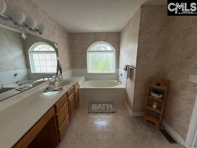 12 Beech Branch Ct, Irmo, SC 29063 - bathroom with a garden tub, a textured ceiling, wallpapered walls, and vanity