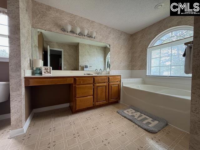 12 Beech Branch Ct, Irmo, SC 29063 - full bath with a garden tub, a textured ceiling, vanity, and tile patterned floors