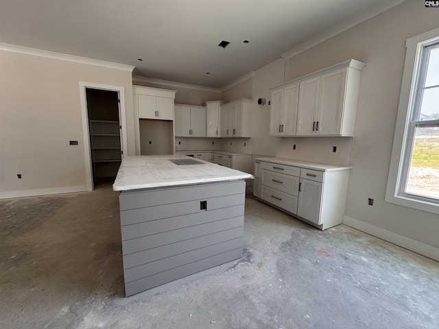 147 Harborside Cir, Columbia, SC 29229 - kitchen with crown molding, concrete flooring, a kitchen island, white cabinets, and baseboards