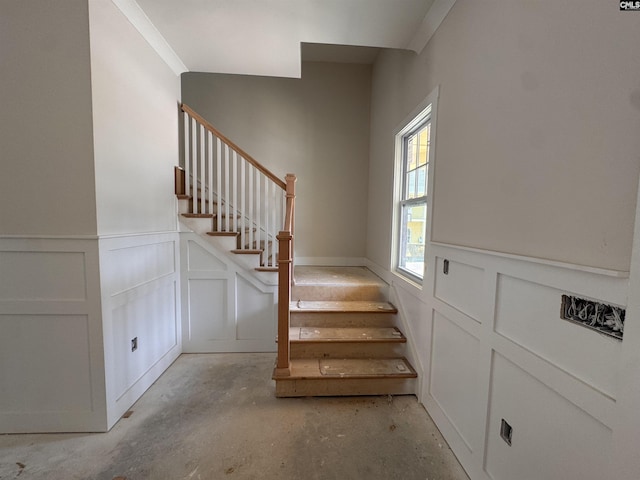 147 Harborside Cir, Columbia, SC 29229 - staircase with a decorative wall, concrete flooring, and wainscoting