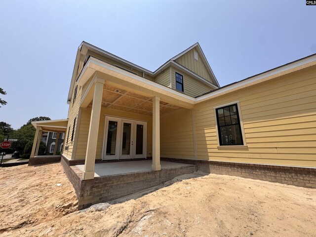 147 Harborside Cir, Columbia, SC 29229 - back of house featuring french doors, board and batten siding, and a patio area