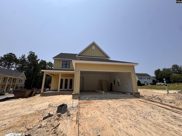 147 Harborside Cir, Columbia, SC 29229 - view of front facade featuring french doors, a garage, board and batten siding, and driveway