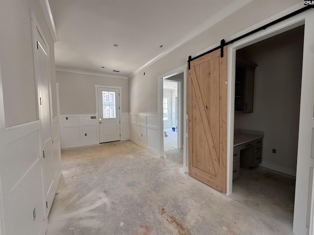 147 Harborside Cir, Columbia, SC 29229 - foyer with ornamental molding, a wainscoted wall, a decorative wall, a barn door, and concrete floors