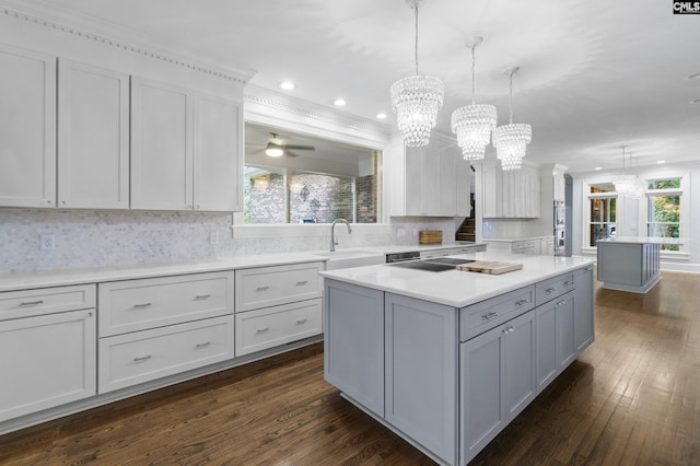 415 Pine St, Camden, SC 29020 - kitchen with a sink, dark wood-style flooring, light countertops, a chandelier, and tasteful backsplash