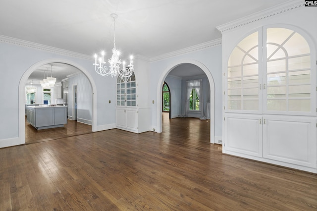 415 Pine St, Camden, SC 29020 - unfurnished dining area featuring arched walkways, a chandelier, dark wood-style flooring, crown molding, and baseboards