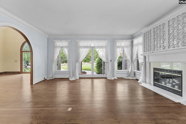 415 Pine St, Camden, SC 29020 - unfurnished living room with ornamental molding, arched walkways, wood finished floors, a fireplace, and baseboards