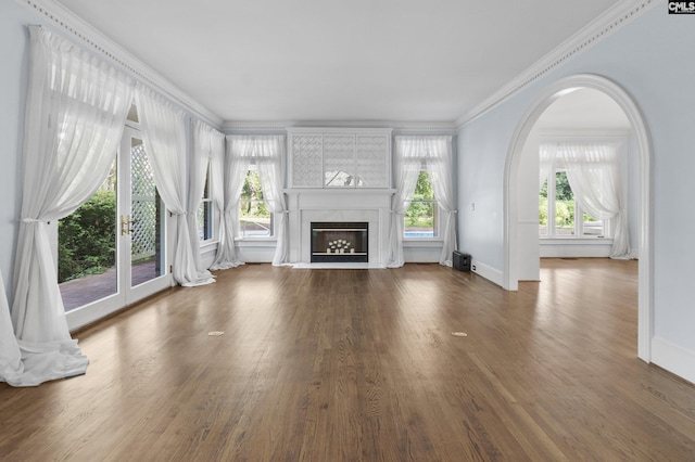 415 Pine St, Camden, SC 29020 - unfurnished living room featuring baseboards, wood finished floors, a fireplace, crown molding, and arched walkways