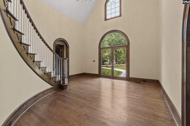 415 Pine St, Camden, SC 29020 - entrance foyer featuring high vaulted ceiling, wood finished floors, arched walkways, stairway, and baseboards