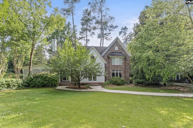 415 Pine St, Camden, SC 29020 - view of front facade with a chimney, a front lawn, and brick siding