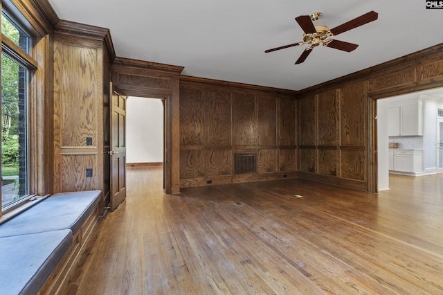 415 Pine St, Camden, SC 29020 - unfurnished living room with wood walls, ornamental molding, hardwood / wood-style floors, and ceiling fan