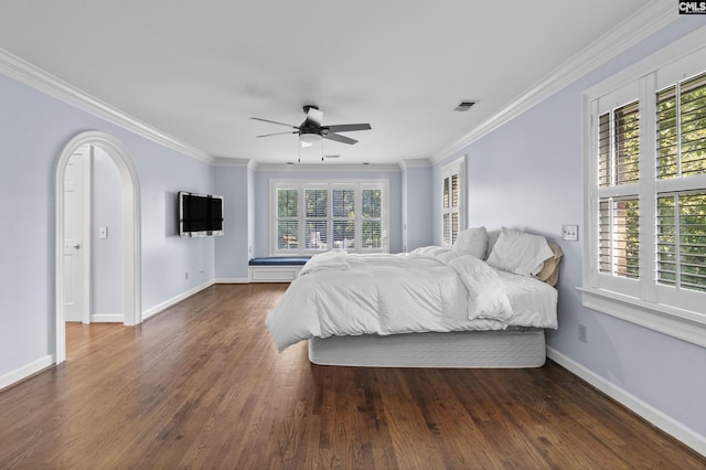 415 Pine St, Camden, SC 29020 - bedroom with arched walkways, baseboards, crown molding, wood finished floors, and ceiling fan