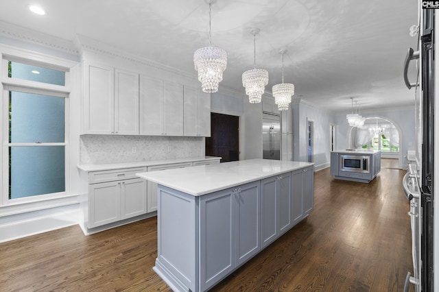 415 Pine St, Camden, SC 29020 - kitchen with a chandelier, built in appliances, light countertops, a kitchen island, and crown molding